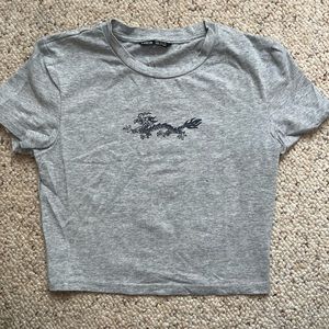 Grey crop top with small dragon symbol